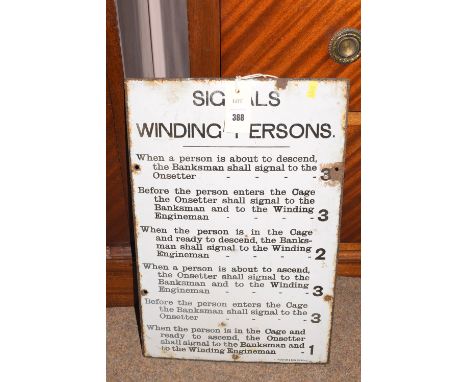 A vintage enamel sign with black writing on white ground, titled 'Signals for winding persons'.
