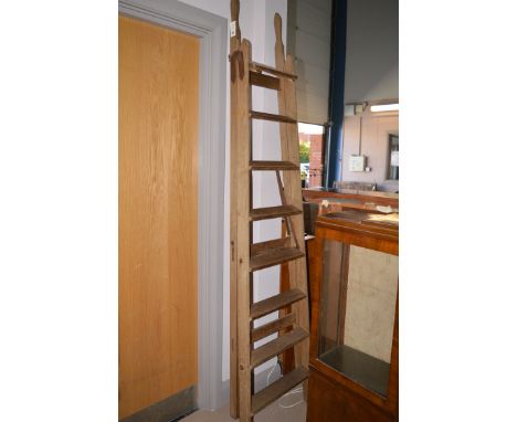 An eight tread folding wooden step ladder.