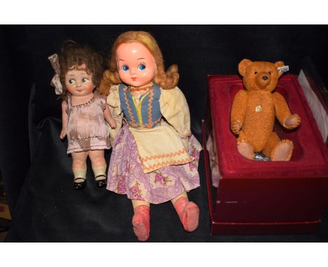 Two early/mid 20th Century doll, one with ceramic head and jointed arms covering a short pink dress; the other with cellulose