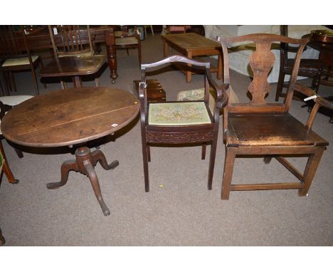 A 19th Century oak tripod table, raised on a turned column with three splay legs, 30in. diameter; a Georgian oak carver chair