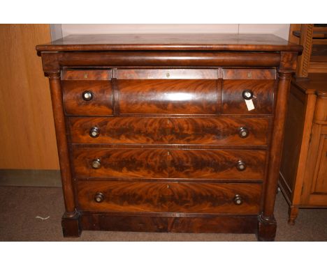 A Victorian mahogany scotch chest of drawers, three short drawers over three long drawers, columns to either side, raised on 