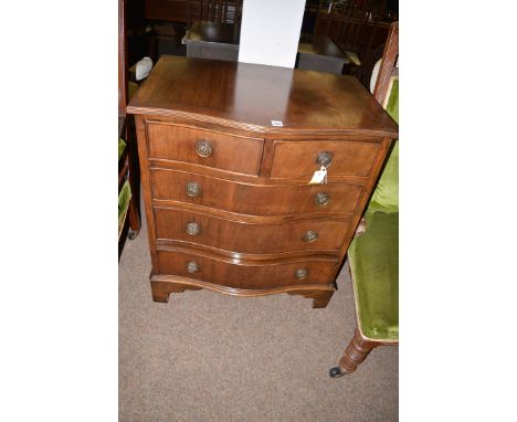 A reproduction mahogany serpentine front chest of drawers, two short and three long drawers, raised on bracket feet, 27in. wi