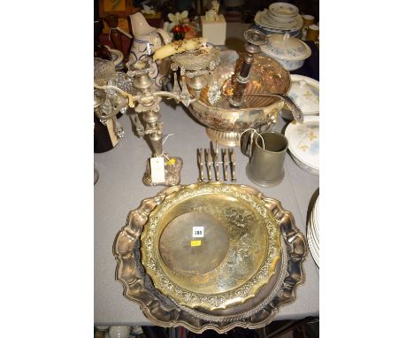 An EPNS punch bowl with lion mask handles; a ladle; a candlestick; toast rack; plated salvers; candelabra; pester tankard; et