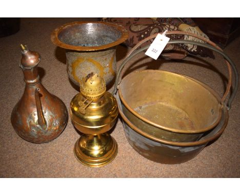 Two brass jam pans; a brass table oil lamp; a middle-eastern copper kettle; and a brass vase.