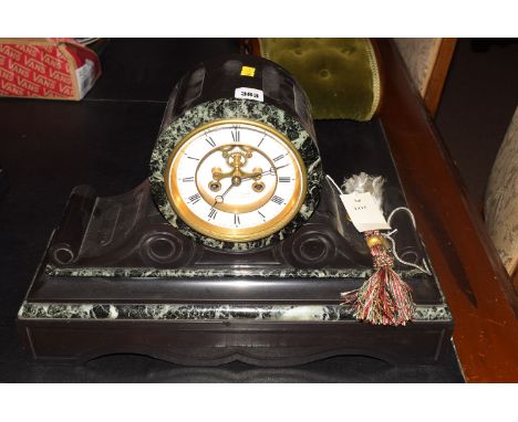 A Victorian slate mantel clock, with white enamel roman dial and visible escapement, maker's mark rubbed to front.