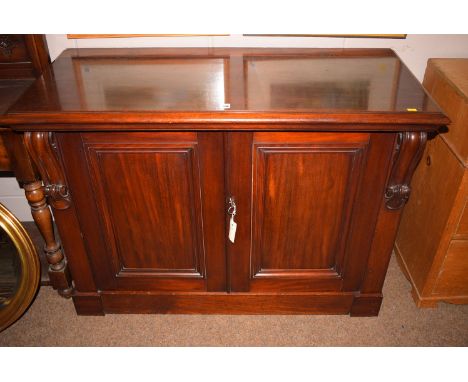 A Victorian mahogany chiffonier, with panel doors, raised on a plinth base (back missing).