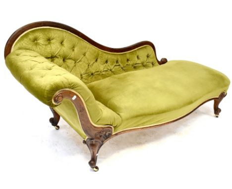 A Victorian walnut chaise longue, button back upholstered in a green velour, with arched back and scroll end, on cabriole leg