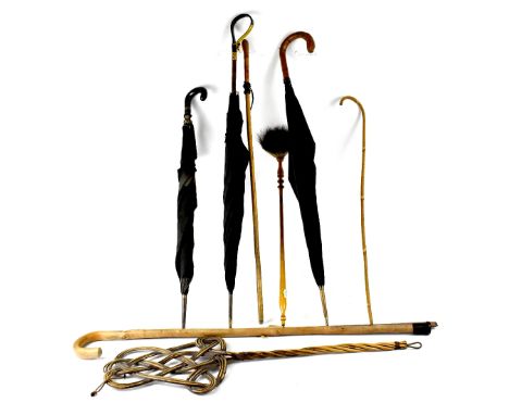 Various canes, walking sticks and umbrellas to include a Victorian bamboo-handled umbrella with horn handle and gilt metal mo