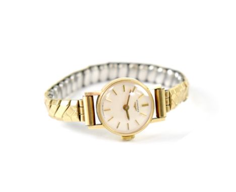 A ladies' vintage 9ct gold manual wind wristwatch on gold plated flexi strap.