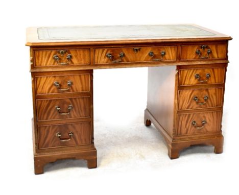 A Georgian-style leather inset mahogany nine-drawer kneehole twin pedestal desk, on bracket feet, 78 x 122 x 61cm. CONDITION 