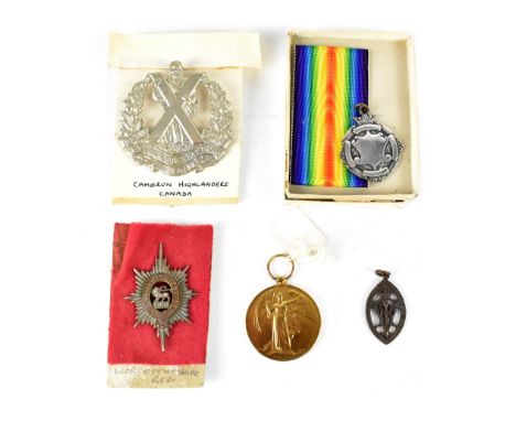 A militaria group comprising a WWI Victory medal, PTE. J. H. Scholes Manch. R. (replica), a white metal military fob, various