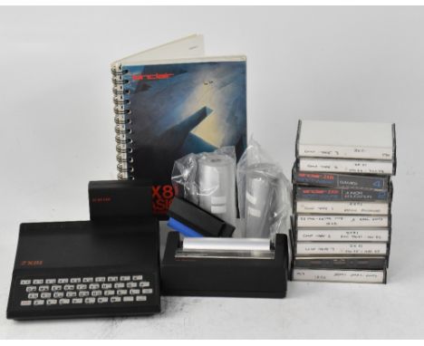 A vintage Sinclair ZX 81 computer with keyboard, power supply, manual, printer, printer card and cable, memory, two original 