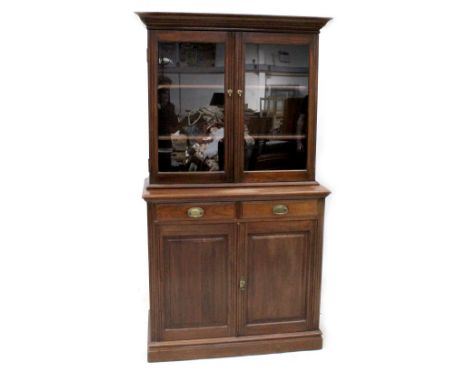 An Edwardian walnut breakfront bookcase, upper section with a pair of glazed doors enclosing two shelves above a base of two 