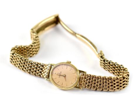Omega; a ladies' vintage 9ct gold manual wind wristwatch with 9ct gold chain link bracelet strap, approx 28.3g.