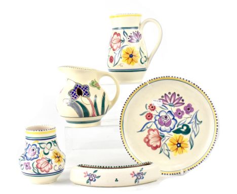 Five pieces of Poole pottery all decorated with flowers within dotted borders, printed marks to base, comprising two jugs, a 