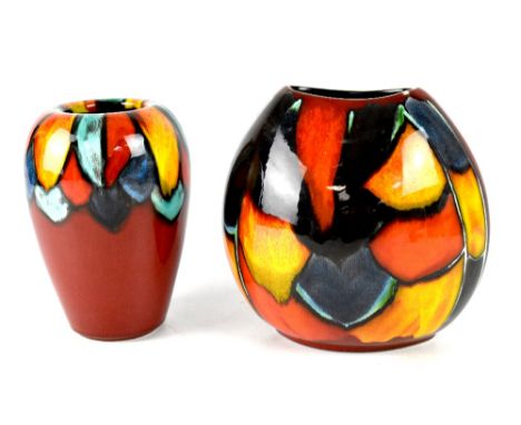 A Poole pottery 'Mosaics' pattern purse vase, height 19cm, and a similar tapering vase of red ground, height 17cm, both with 