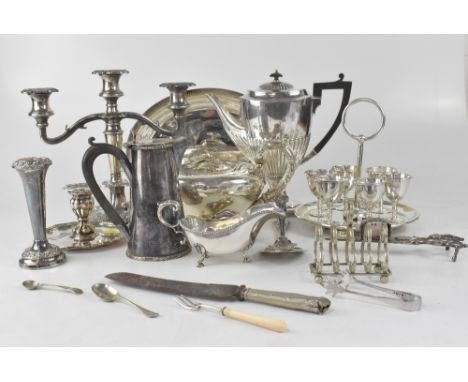 A quantity of plated ware to include 19th century teapot, coffee pot, napkin rings, candle snuffer, asparagus tongs, chamber 