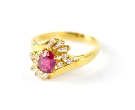 An 18ct yellow gold flower cluster ring with central ruby surrounded with six baguettes and six small brilliants in a modern 