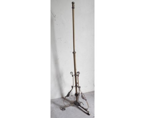 A late Victorian brass telescopic lamp standard, with scrolling leaf base.