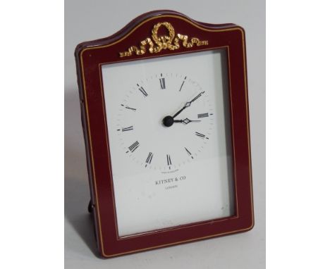 A modern quartz timepiece, by Kitney & Co London, the white dial enclosed within a red enamel and velvet case with gilt crest