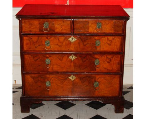 A 18thC walnut chest, of two short and three long graduated drawers with herringbone and watered veneer top, with lion mask h
