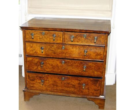 A mid 18thC walnut and burr walnut chest of drawers, with a feather and crossbanded top above two short and three long drawer