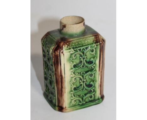 An 18thC Staffordshire pottery Whieldon type tea caddy, the shouldered square body with an upper bead banding raised with scr