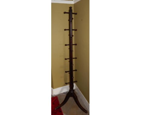 A turned mahogany hat and coat stand, on three outsplay legs.
