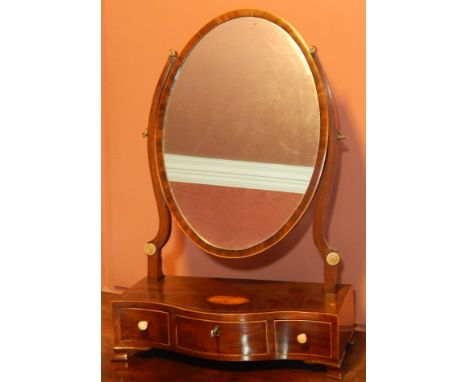 An early 19thC mahogany and boxwood strung dressing table mirror, the oval plate on shaped supports applied with bone roundel