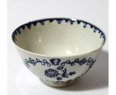 An 18thC blue and white porcelain tea bowl, the cylindrical body decorated with panels of flowers, on circular foot, with inn