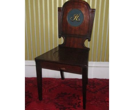 A George IV mahogany hall chair, the shaped back painted to the centre with the letter 'R', with a solid seat on square taper