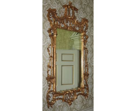 A pair of gilt wall mirrors in the Chinese Chippendale style, each elaborately decorated with a pagoda to the top above folia
