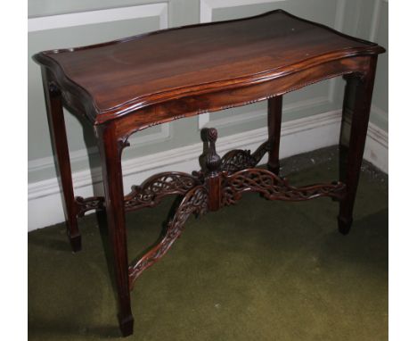 A modern mahogany table in Chippendale style, the shaped top with a raised border, the frieze with bead and reel edging on sq