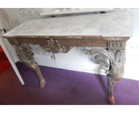 A Continental gilt gesso console table, with a Greek key border applied with scroll moulding on shaped legs with pierced brac