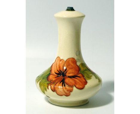 A Moorcroft pottery table lamp, of baluster form, decorated in the Hibiscus pattern, 18cm high.