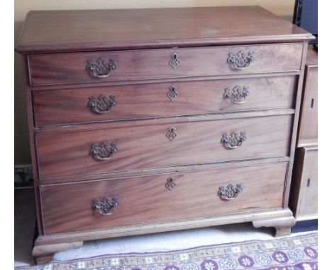 A George III mahogany chest of drawers, the rectangular top with a moulded edge above a fitted drawer with writing slope etc.