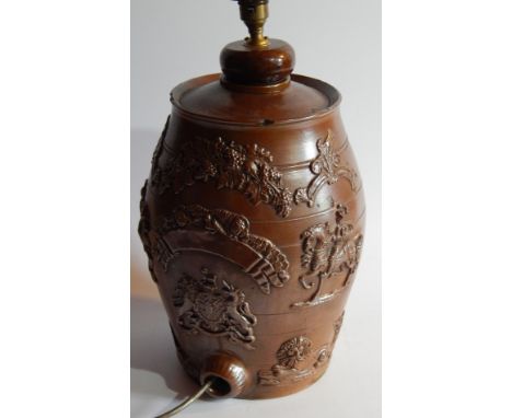 A mid-19thC brown stoneware spirit barrel, the oval body with leaf decoration with upper berries and leaves and centred by li