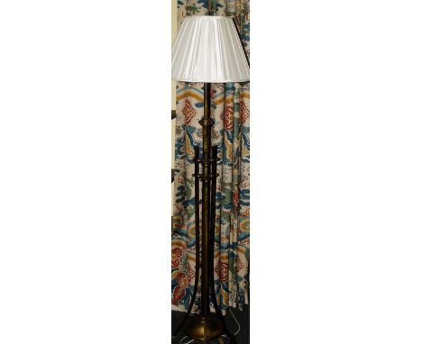 A late 19thC/early 20thC brass Art Nouveau floor lamp, with a central cylindrical column, square sectioned splayed supports a
