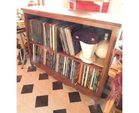 A 19thC Continental oak open bookcase, the top with a moulded edge above a shelf on short scrolling feet, 105cm high, 122cm w