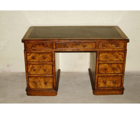 A Victorian figured and burr walnut twin pedestal desk, with gilt tooled skiver, three frieze drawers and three to each pedes