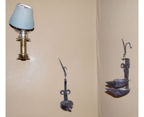 Two wrought iron wall mounted oil lamps, and a brass wall lamp fitted for  electricity (3).