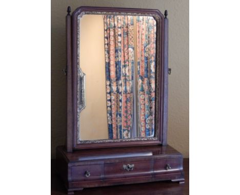 A late 18thC/early 19thC mahogany dressing table mirror, the rectangular plate with parcel gilt slip on tapering supports, th