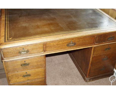 A Victorian oak partners desk, with moulded top having leather inset, with three frieze drawers and three drawers to each ped