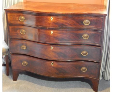 An early 19thC mahogany serpentine fronted chest of drawers, with an arrangement of four graduated drawers, each with later P