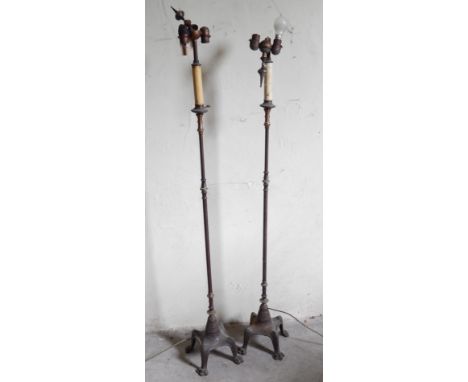 A pair of Victorian cast iron lamp standards, with gilded and anodised column, converted to electricity.