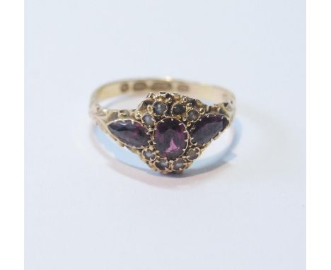Victorian garnet and pearl ring, in 15ct gold, 1871, size Q.CONDITION REPORT: Pearls are all present, but at unequal heights.