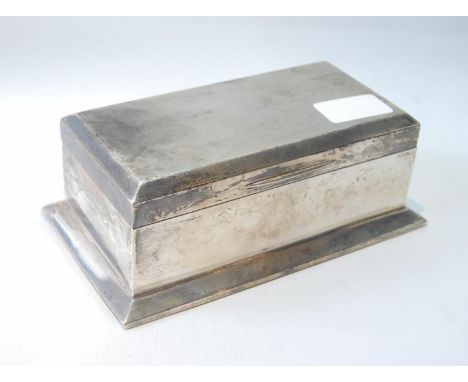 Silver cigarette box with engine turned top, on spreading base, Birmingham 1927, 18.5cm x 10.5cm.CONDITION REPORT: Minor dist