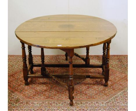 Charles II style antique oak gate-leg table, with drop ends, on turned jointed supports and beam under stretchers, 77cm high,