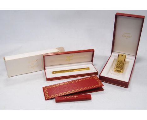 Must de Cartier gold plated ballpoint pen with engine turned decoration, no. 034221, with fitted box, guarantee card, booklet