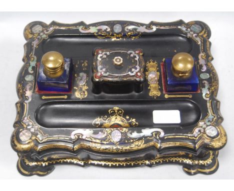 Victorian black papier mâché gilt and mother of pearl desk stand with integral stamp box and pen wells, with two later blue g